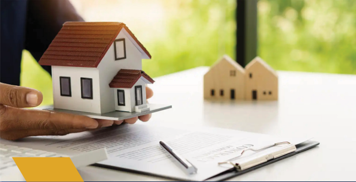 Modelo de habitação sobre documentos imobiliários